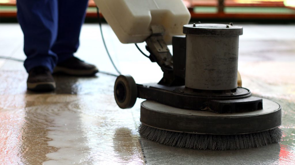 Commercial floor cleaning team buffing office flooring