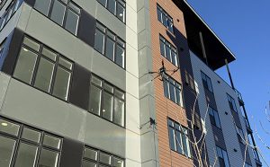 Drone Window Cleaning Calgary Commercial Buildings Drone cleaning exterior glass on a multi story commercial building in Calgary using aerial window cleaning technology
