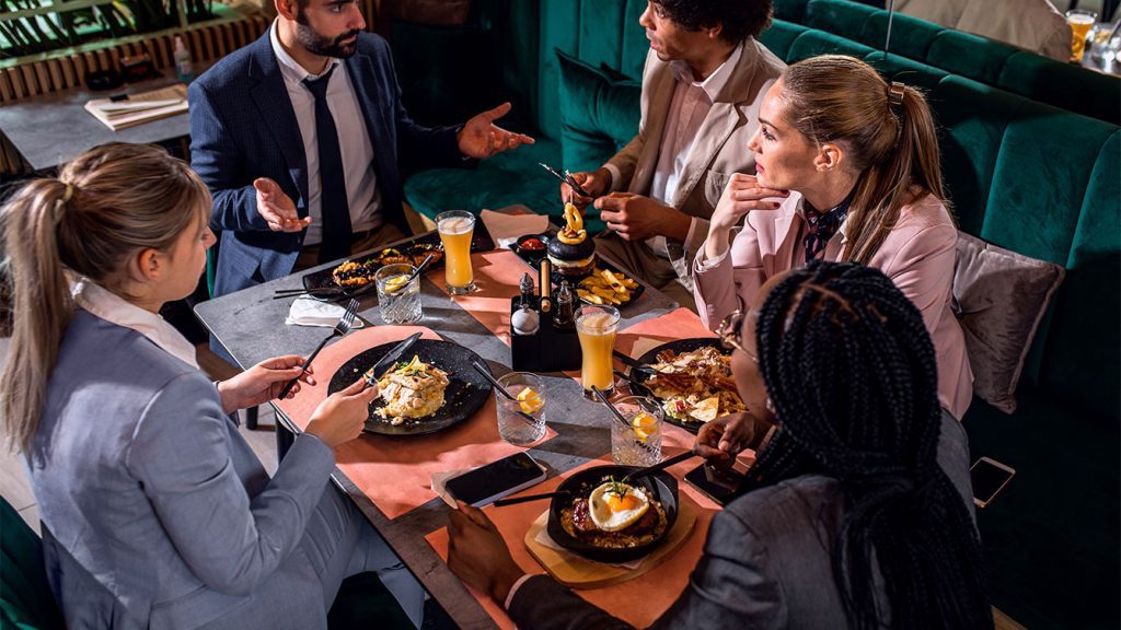 Happy restaurant clients dining in a clean environment thanks to professional commercial kitchen cleaning by Eshine Cleaning Services